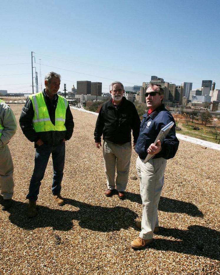 A team inspects a storm-damaged roof in Atlanta
