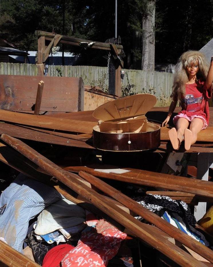 Water-damaged belongings piled outside a home
