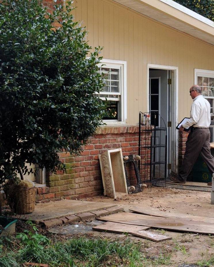 Inspectors at the door of a damaged home in DeKalb County, Georgia
