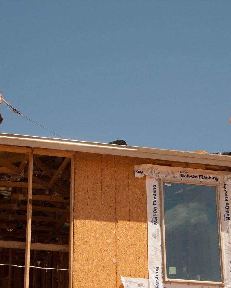 Crew on the framed roof of a new house